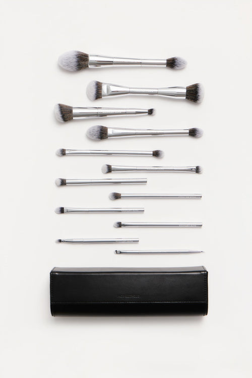 Method 01 Brush Collection: 12 silver makeup brushes laid out with the black brush clutch